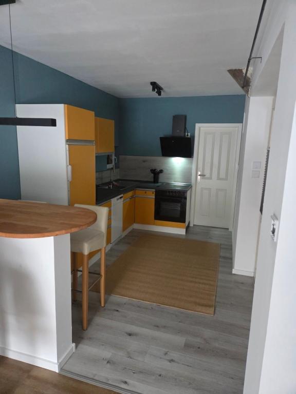 a small kitchen with a table and a refrigerator at Ferienwohnung Noltenius 2 in Bülstedt