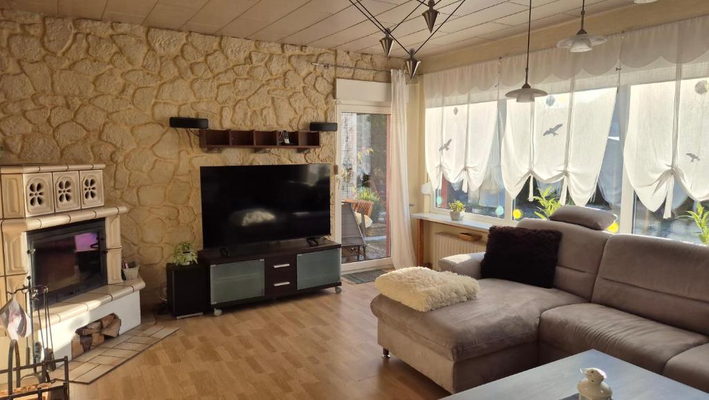 a living room with a couch and a flat screen tv at Haus Ferien Bock in Clausthal-Zellerfeld
