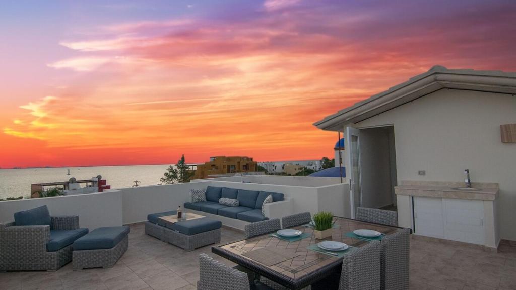a sunset on the roof of a house at Experience Luxury on Isla Mujeres! in Isla Mujeres