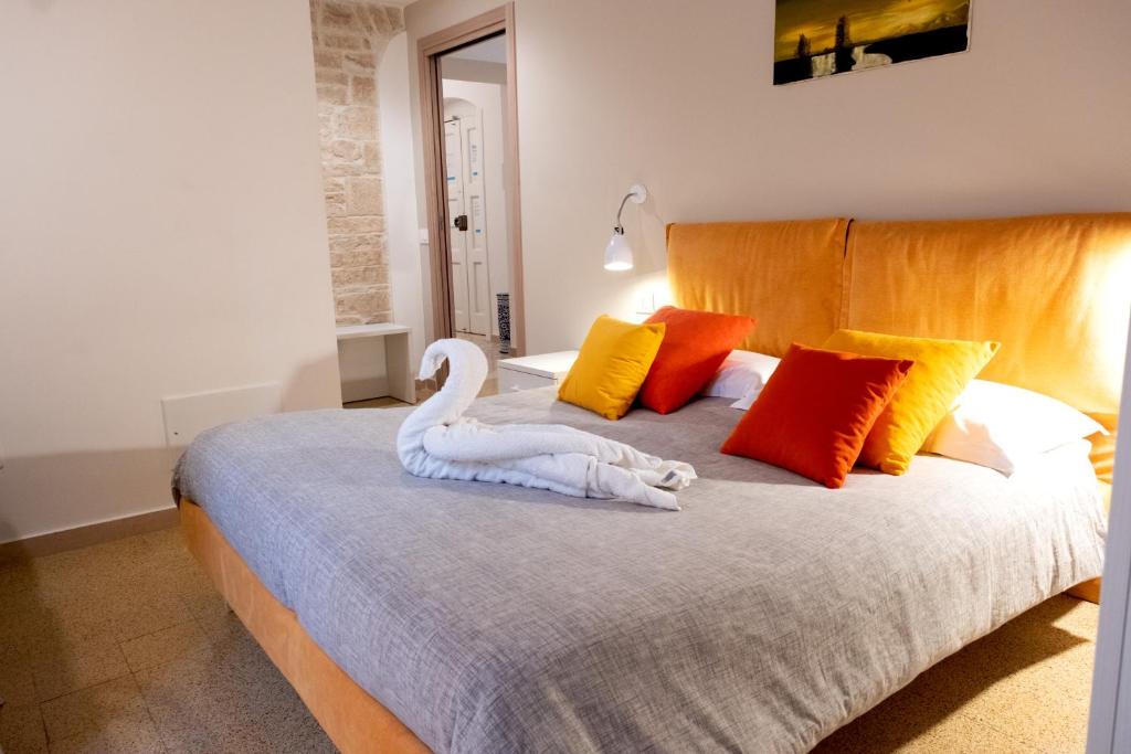 a bedroom with a bed with a swan on it at Le Gravinelle - Apulia Houses & Flats in Ruvo di Puglia