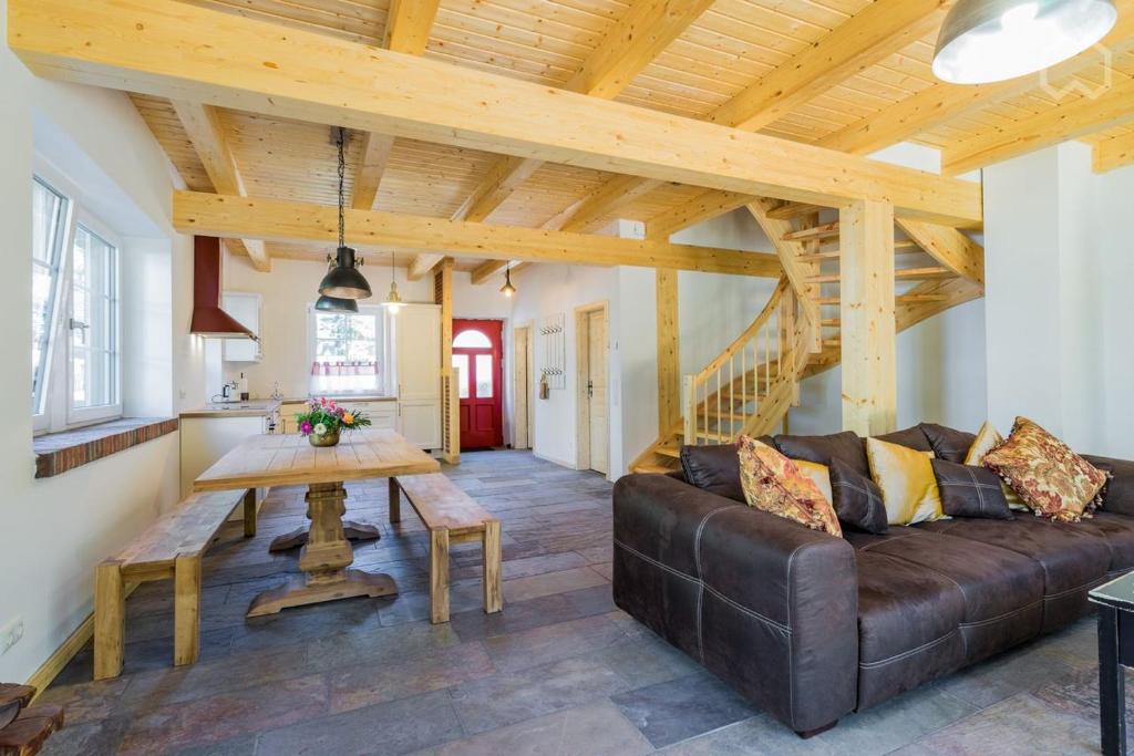 a living room with a couch and a table at Welsh Dragon in Siedlung Schönwalde