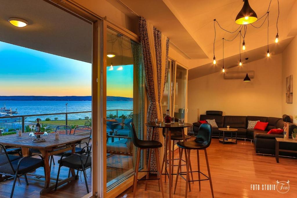 a living room with a view of the ocean at Apartments KIDS in Kaštela
