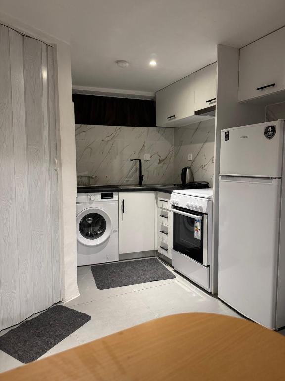a kitchen with a white refrigerator and a dishwasher at Guest house 2 in Amalias