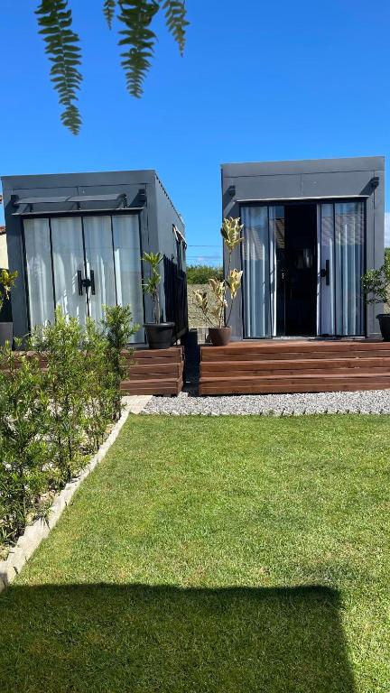 a house with a lawn in front of it at Studio 02 Container Aeroporto in Florianópolis
