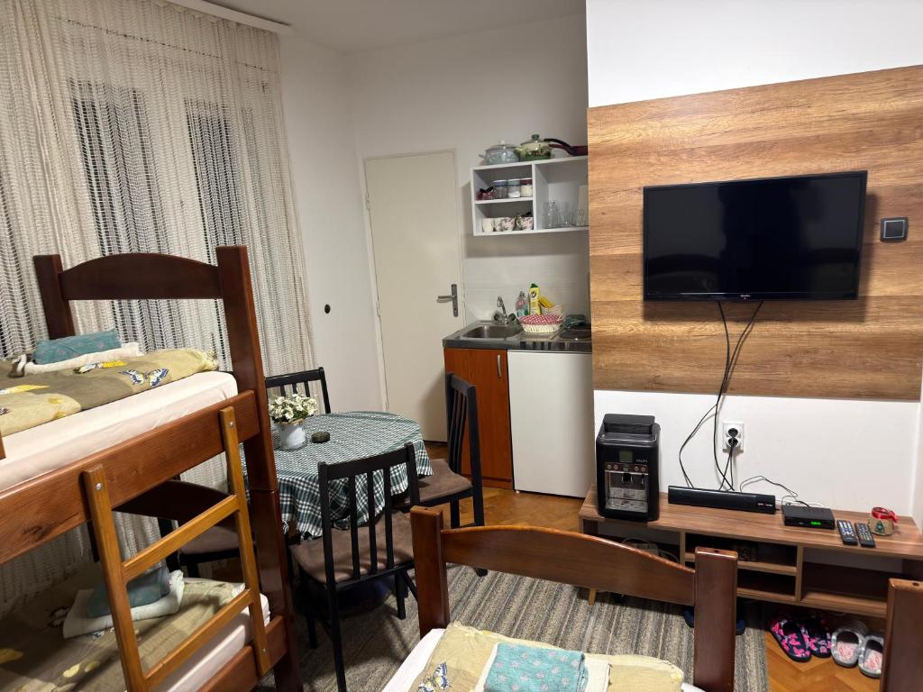 a living room with a flat screen tv on a wall at Tim in Kalna