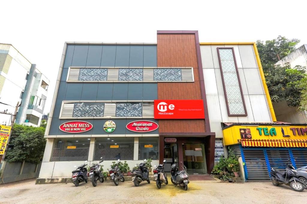 a group of motorcycles parked in front of a building at Hotel Mini Escape Perungalathur in Chennai