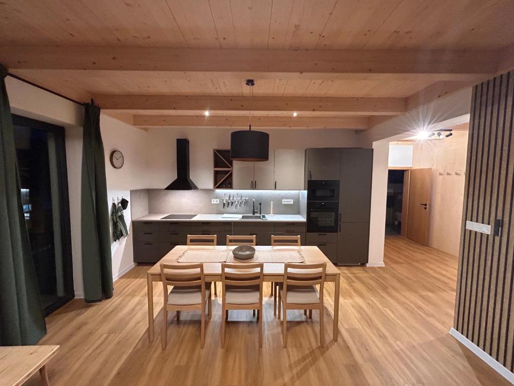 a kitchen with a table and chairs in a room at Apartmánový dom DK Ateliér in Dolný Kubín