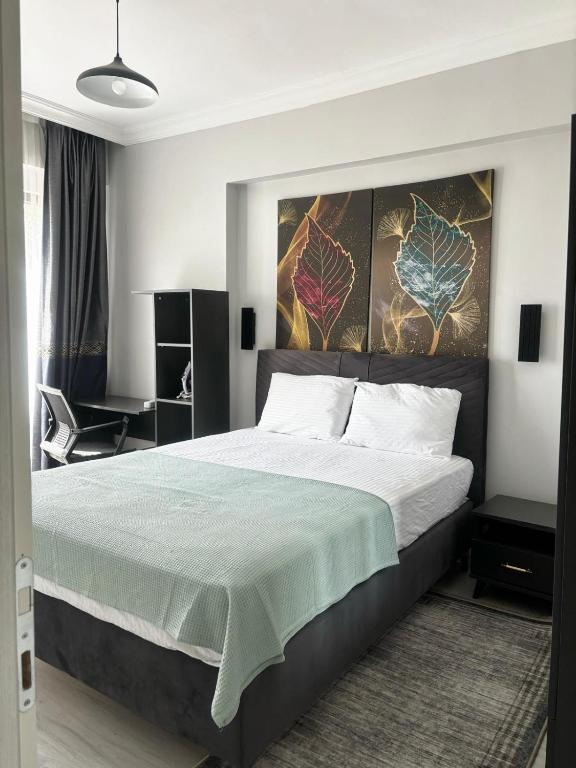 a bedroom with a large bed with a green blanket at Sevez Apartments & Homes in Gelibolu