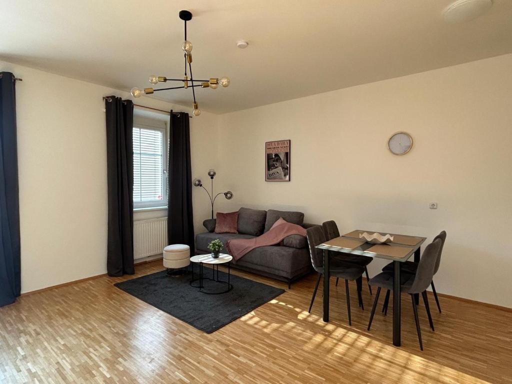 a living room with a couch and a table at Faraway Homes Studio Krieglach #7 in Sommer