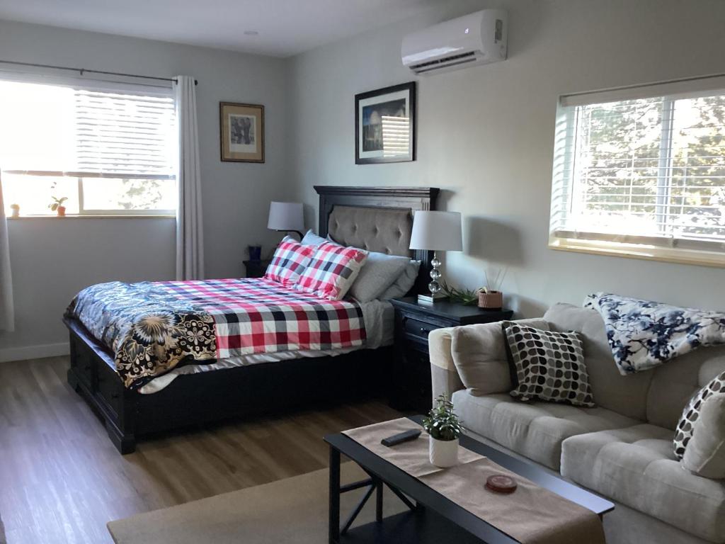 a living room with a bed and a couch at The Cozy Nook in Grand Forks