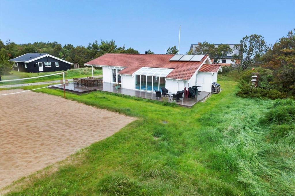 a white house with a red roof on a beach at 931-Thisted-Pinbak-24 in Torsted
