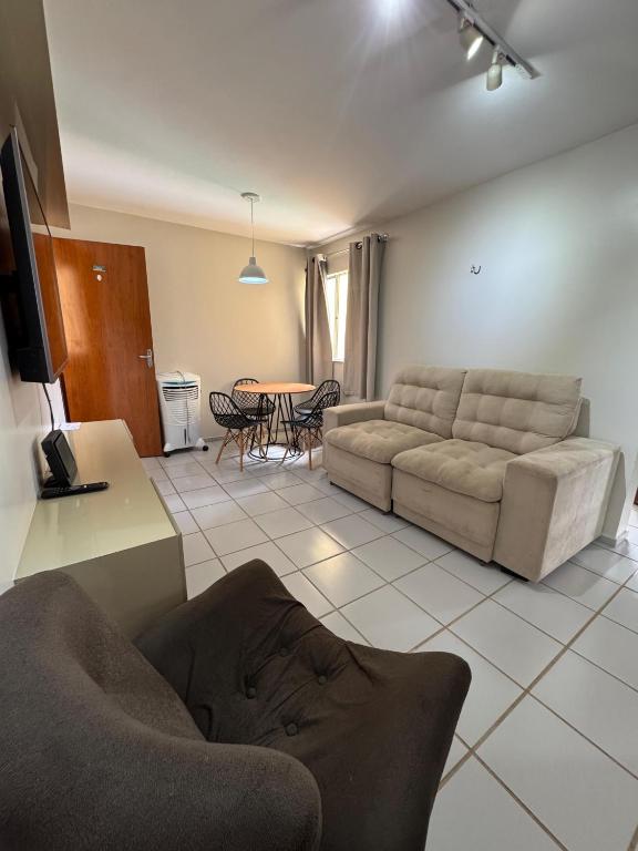 a living room with a couch and a table at Apartamento confortável in São Luís