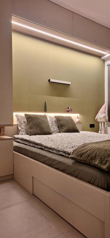 a bedroom with a large bed in a room at River2Mountain Cozy Apartment in Gozd Martuljek