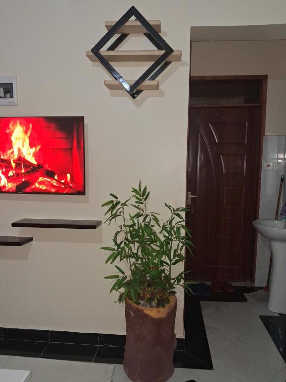 a bathroom with a fire painting on the wall at Town Stays in Voi