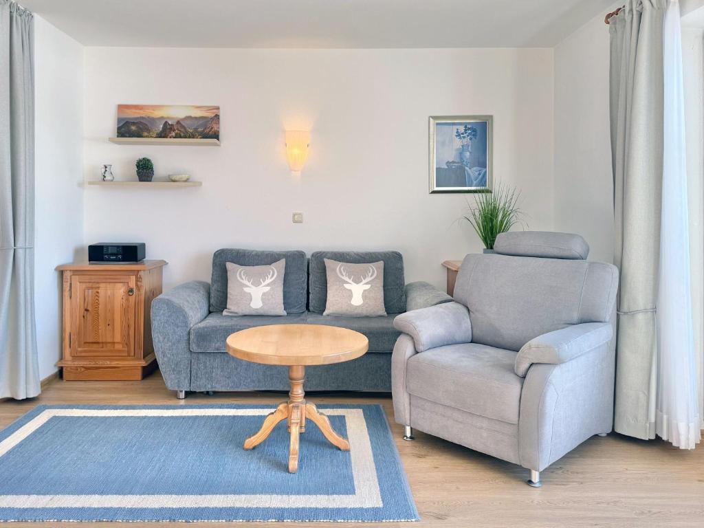 a living room with a couch and a chair and a table at Sonnenhof Seeg 07 in Seeg