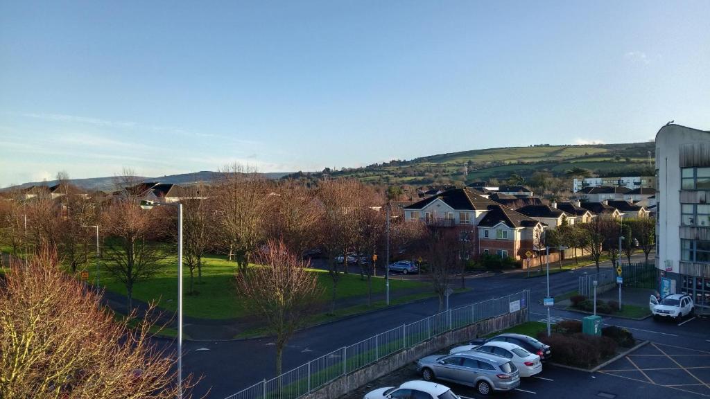 a city with cars parked in a parking lot at Citywest 2 Bed Apartment in Citywest
