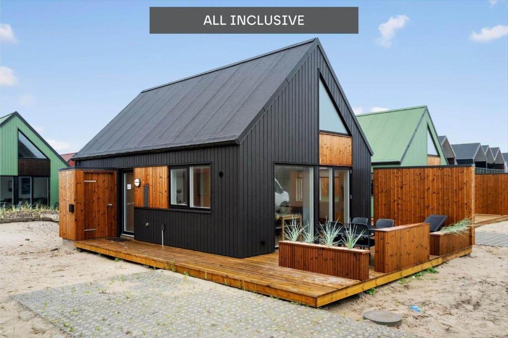 a black house with a black roof at 9952-Hvide-Sande-Langsand-204 in Hvide Sande
