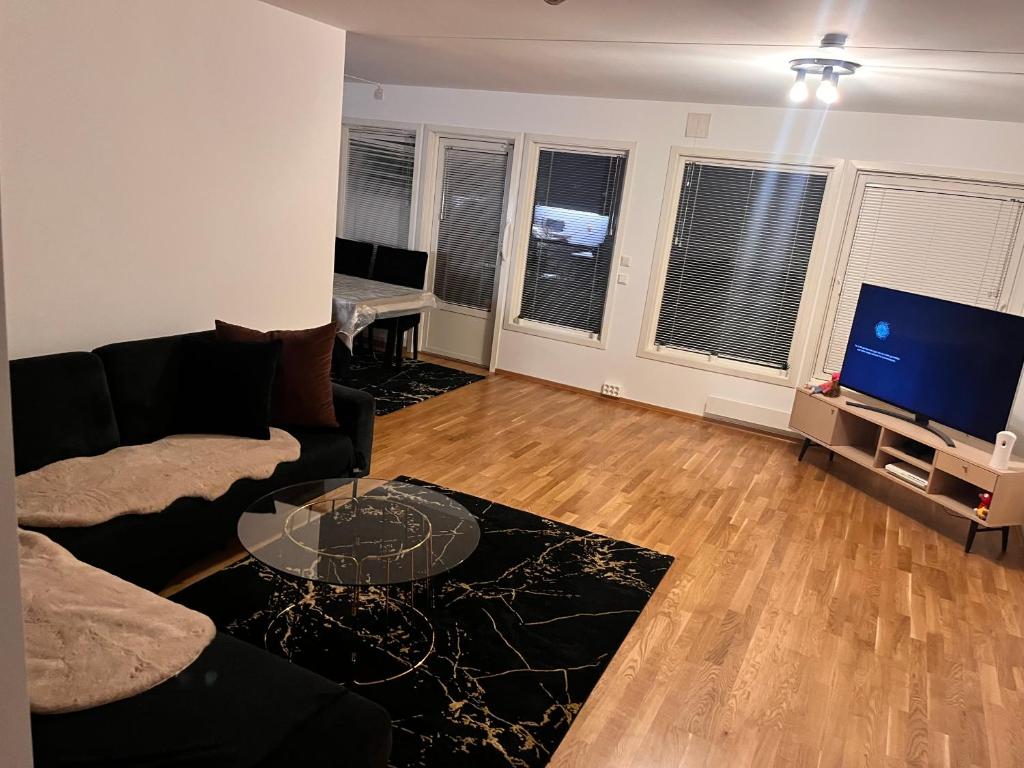a living room with a couch and a flat screen tv at Klaus torgårds vei 8b in Oslo