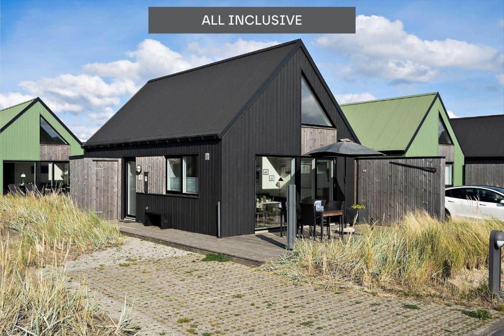a black house with a black roof at 945-Hvide-Sande-Langsand-163 in Hvide Sande