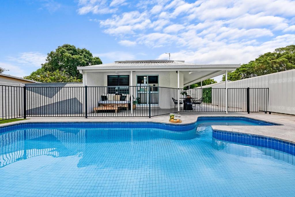 a swimming pool in front of a house at The Boho Casa - Beachside Retreat with Pool in Darwin