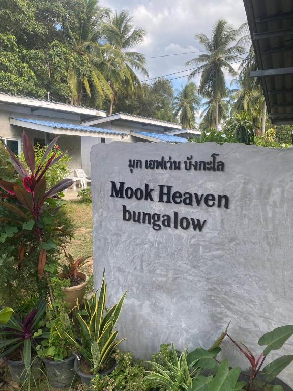 a sign for a hotel in front of some plants at Mook Heaven Bungalow in Ko Mook