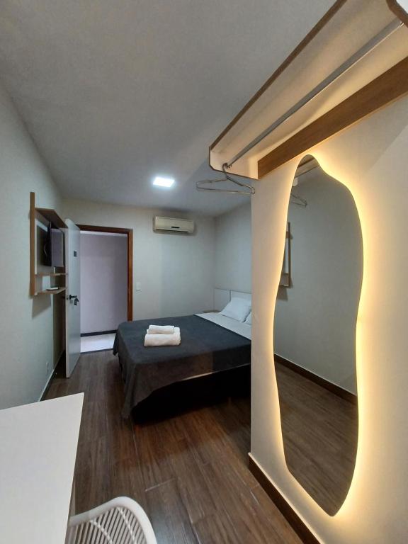 a small room with a bed and a table at Riviera Sanary 1208 Nova Almeida in Serra
