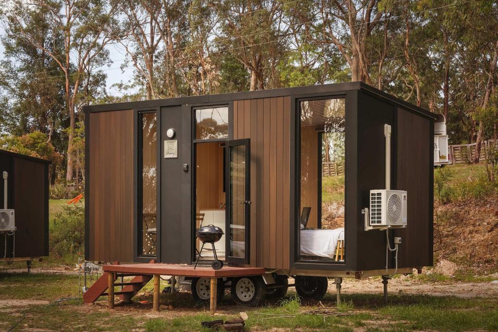 a tiny house on a trailer in a field at Maroota Greens SKY by Tiny Away in Maroota