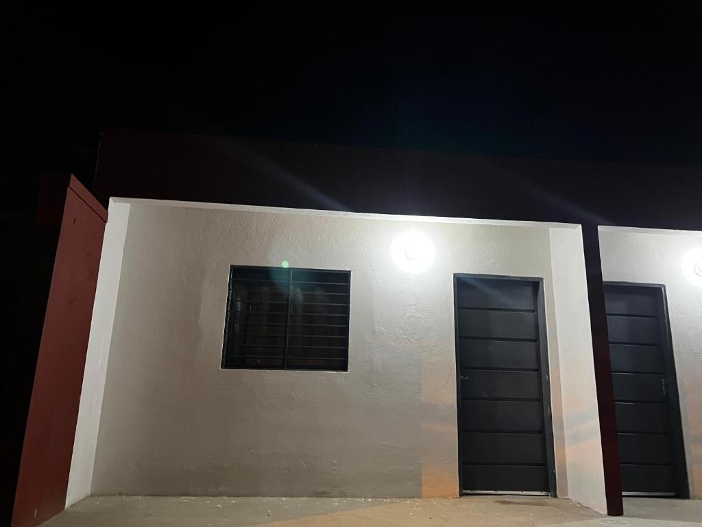 a building with two doors and a window at Residencial Lapacho 2 in Luque