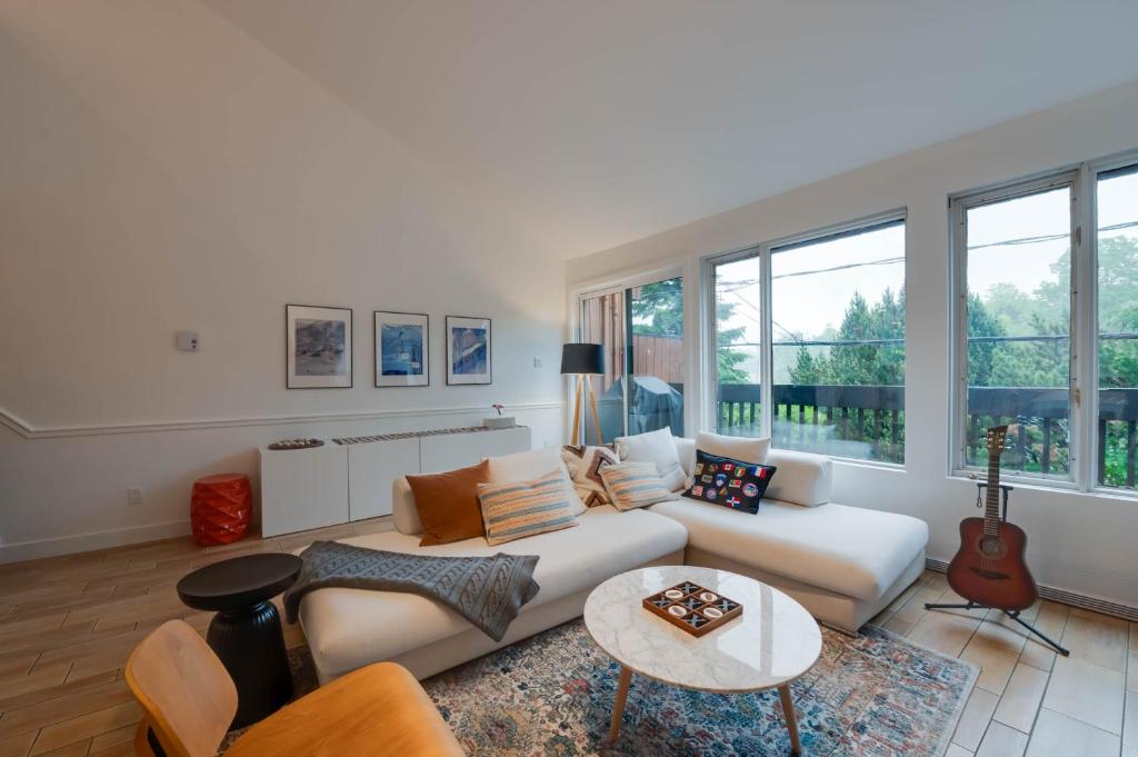 a living room with a couch and a table at Unité 17 - Ski-in Ski-out in Beaupré
