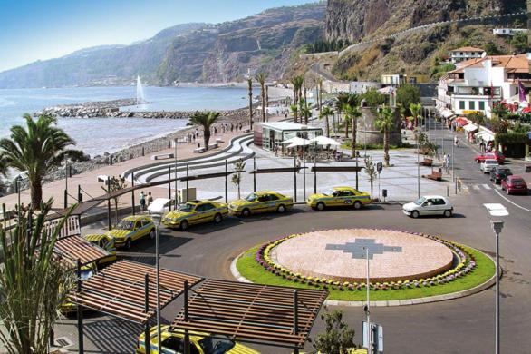 a group of cars parked in a parking lot near the beach at Giesta Flower by Madeira Holiday Rentals in Ribeira Brava