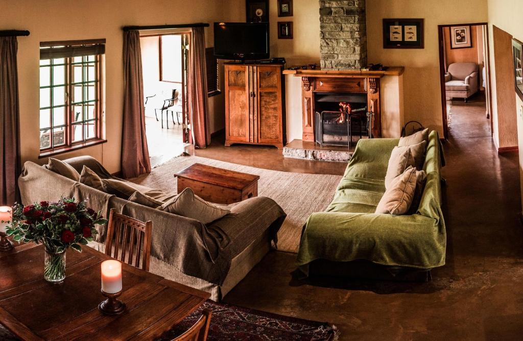 a living room with a couch and a table at The FarSide Dam Cottage in Nottingham Road