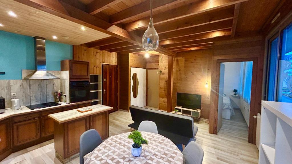 a kitchen and dining room with a table and chairs at T2 Aix-Les-Bains atmosphere chalet in Aix-les-Bains
