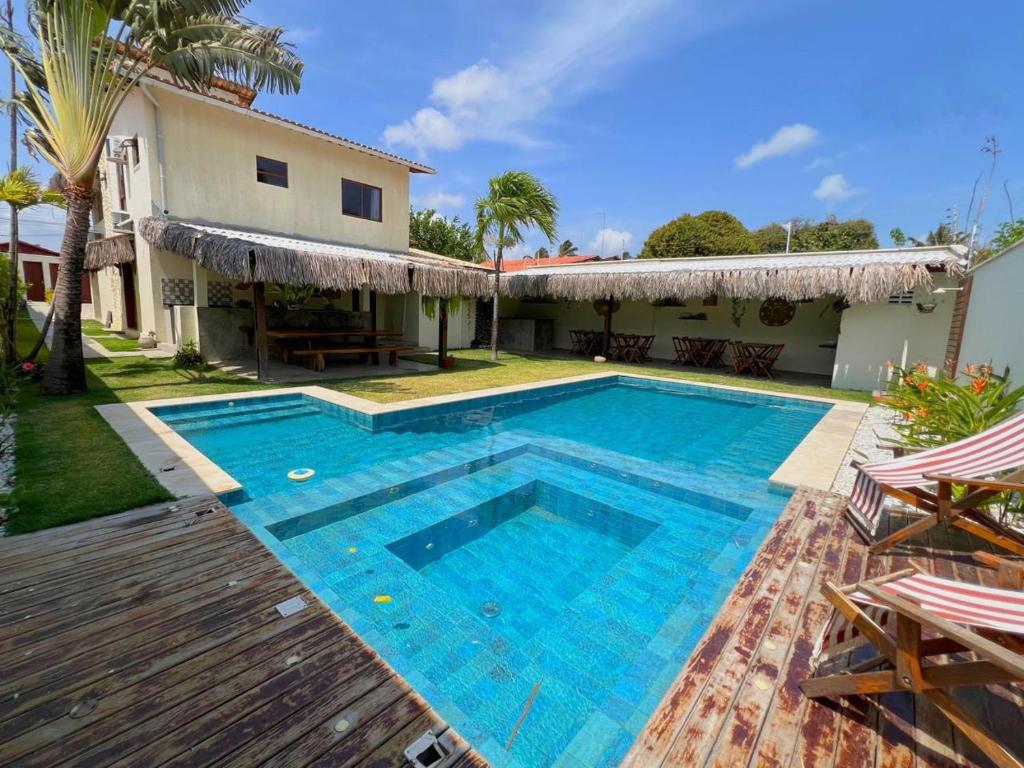 a swimming pool in front of a house at Casa levante in Paracuru