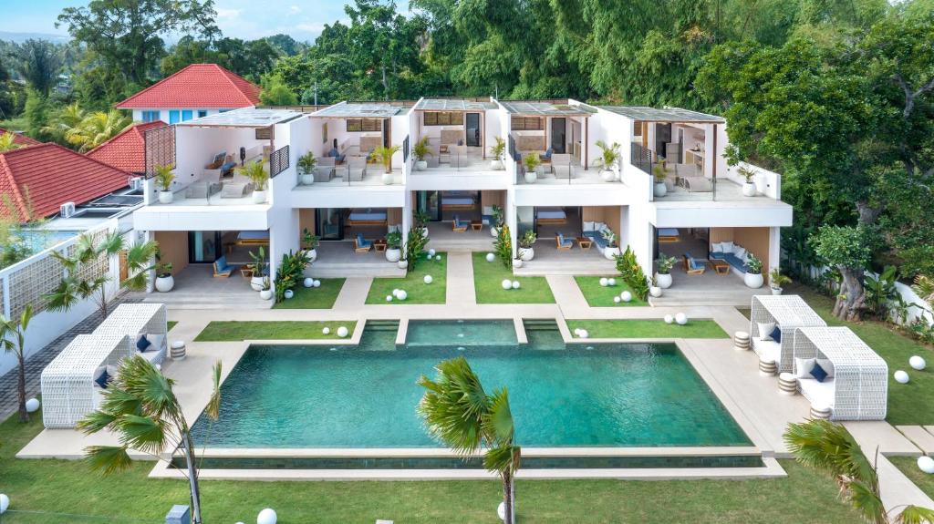 an aerial view of a house with a swimming pool at Bohemian Beachfront Apartments in Pabean Buleleng