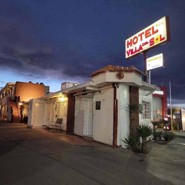 a hotel inn with a sign on a street at hotel villa del sol chihuahua in Chihuahua