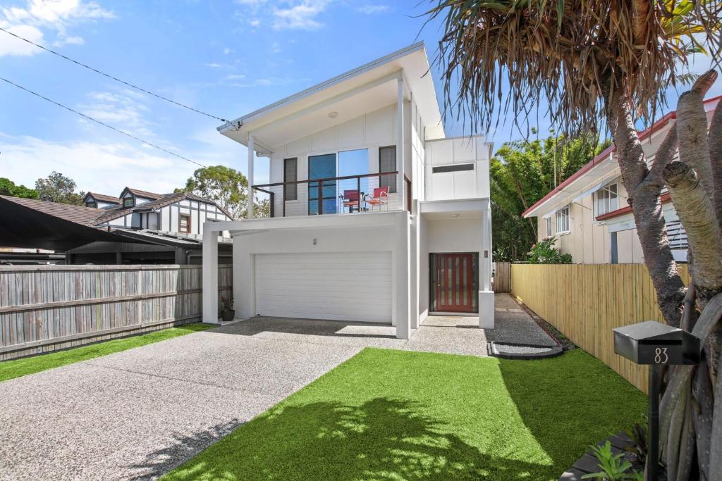 a white house with a fence and a driveway at Roderick Street 83, Moffat Beach in Caloundra