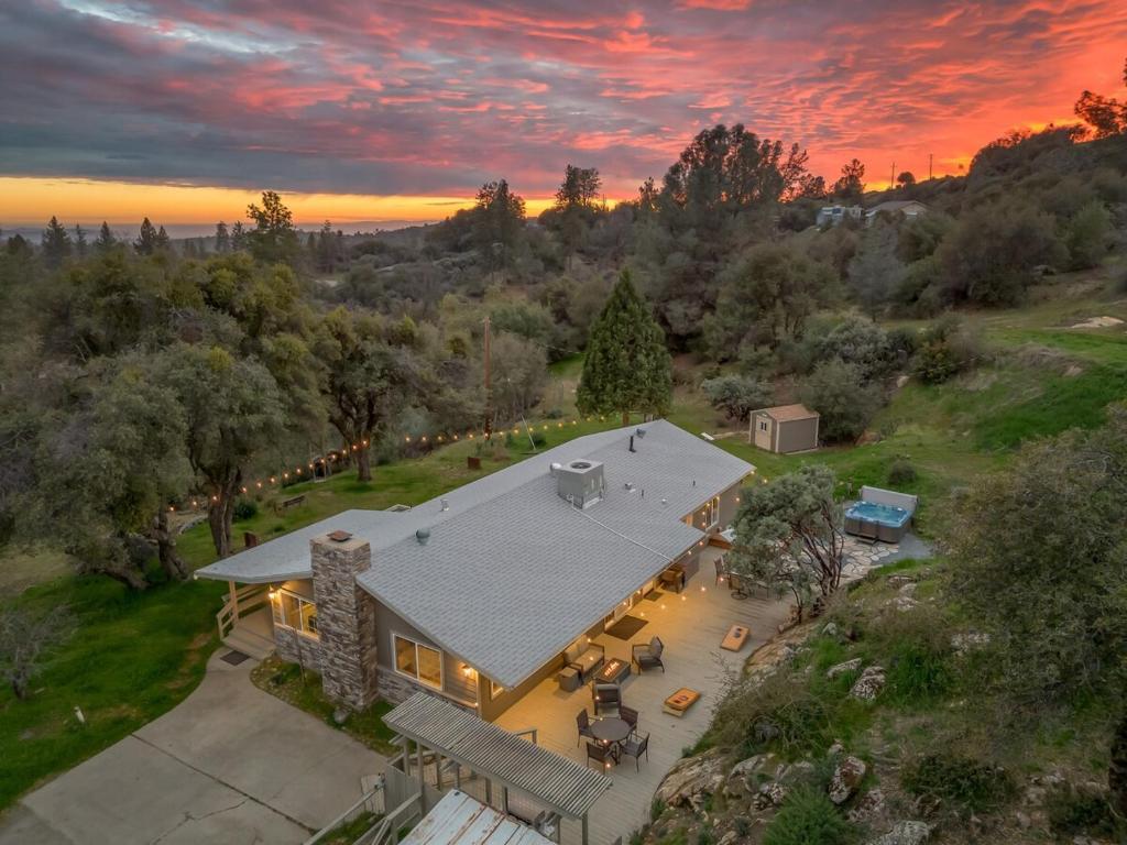an aerial view of a house with a sunset at Manzanita Hill-35 miles to Yosemite, 10 miles to Mariposa with 8 person spa in Mariposa
