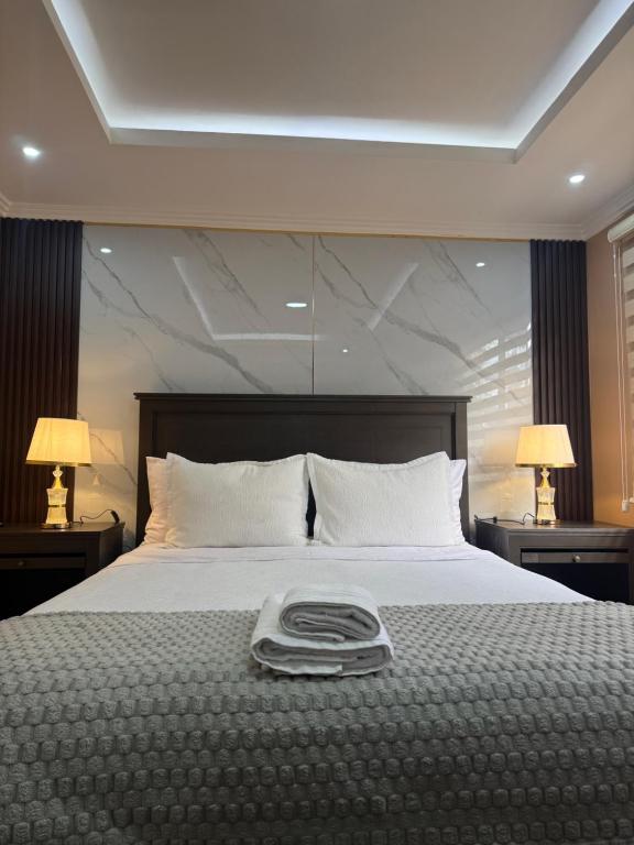 a bedroom with a large bed with two lamps at House in Miraflores Cuenca in Cuenca