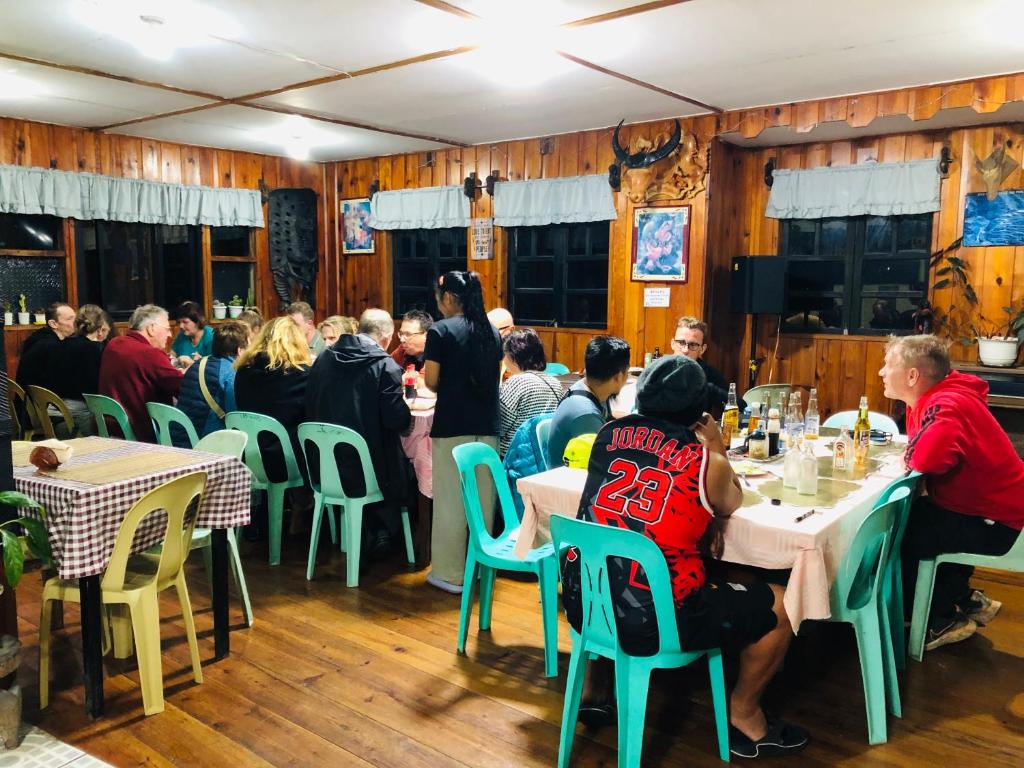 a group of people sitting at tables in a restaurant at Las vegas lodge and restaurant in Banaue