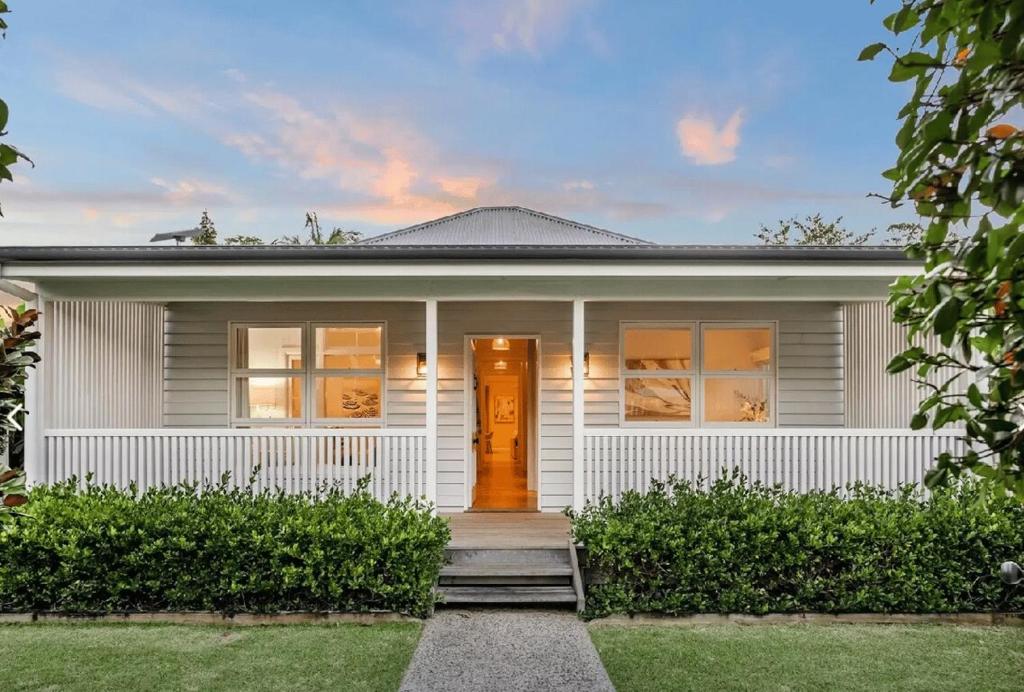 a white house with a front door at Paddy's Place in Bangalow