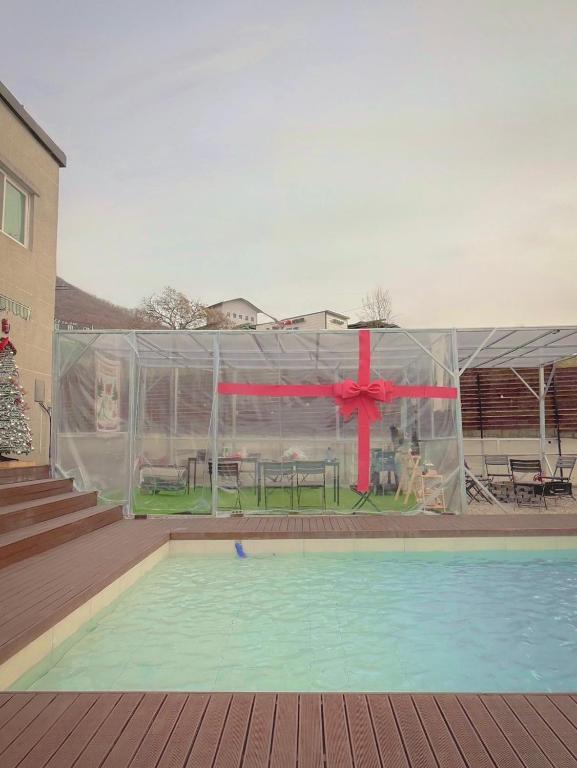 a marquee with a pool and a red bow at Dohwa Pension Cheongju in Cheongju