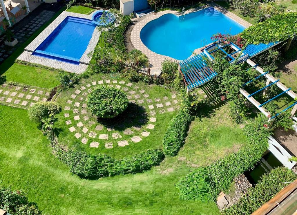 an overhead view of a garden with a swimming pool at Alzurich Private Resort in Dauin