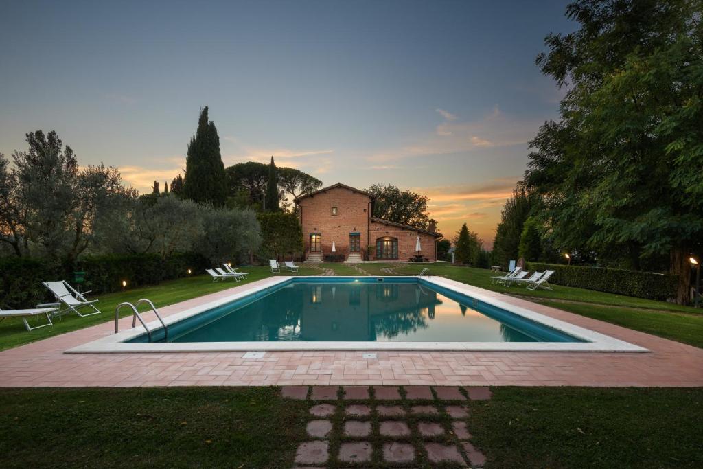 a swimming pool in the yard of a house at La Casa Delle Querce in Acquaviva