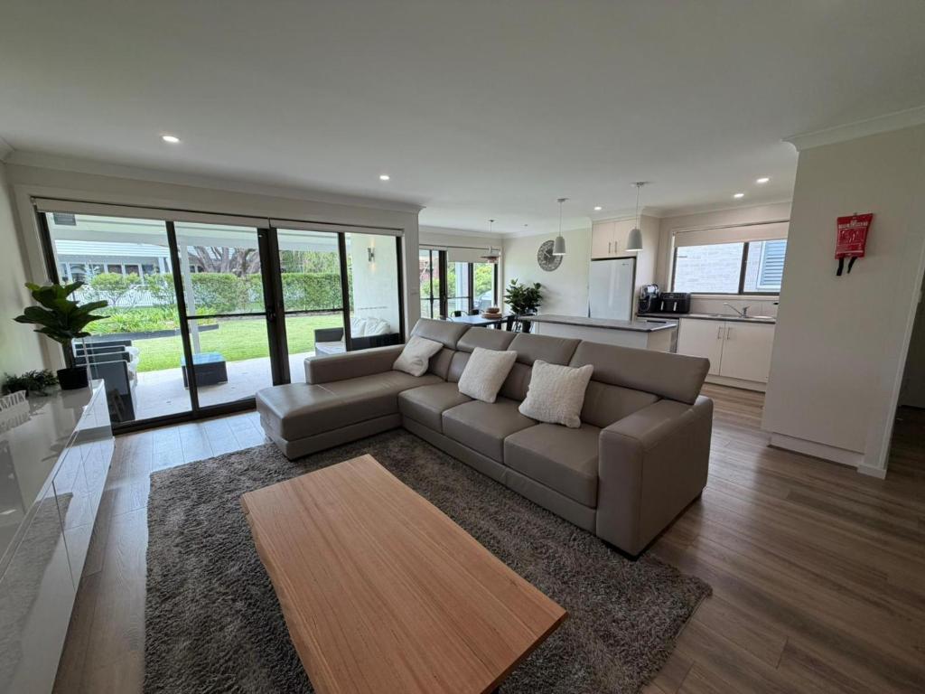 a living room with a couch and a kitchen at Mistral Breeze in Nelson Bay