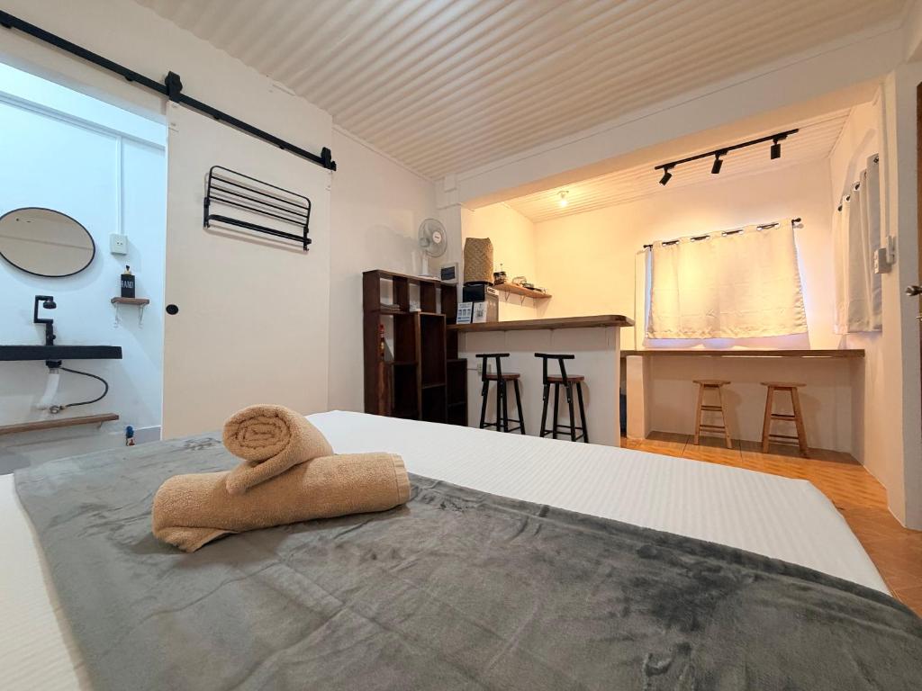 a bedroom with a towel sitting on a bed at New studio General Luna in General Luna
