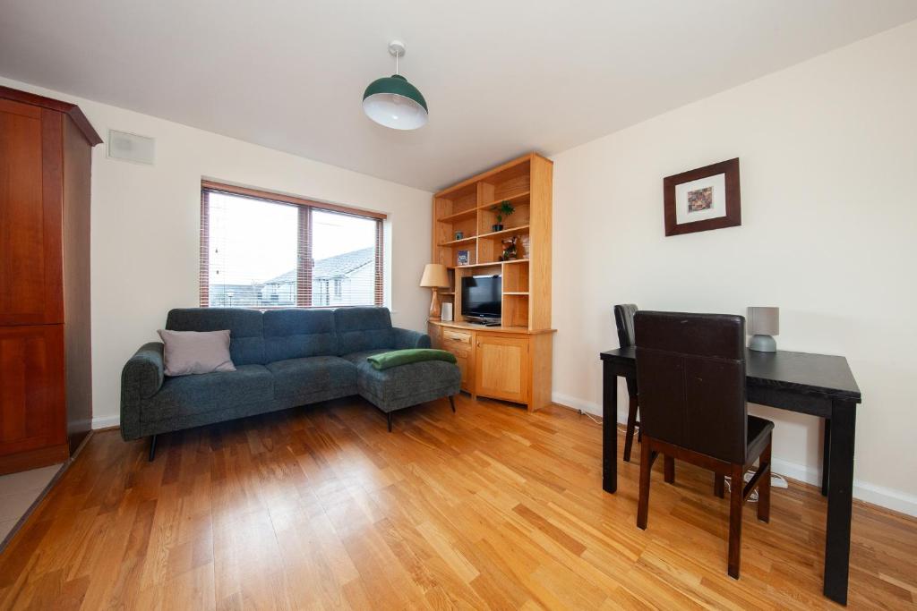 a living room with a couch and a table at Spacious 2BDR Flat Near Portmarnock Beach in Dublin