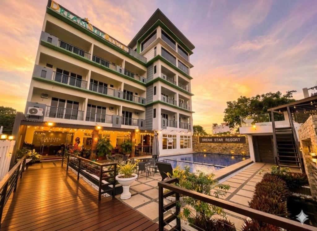 a building with a deck and a pool at Dream'Star Resort in Puerto Galera