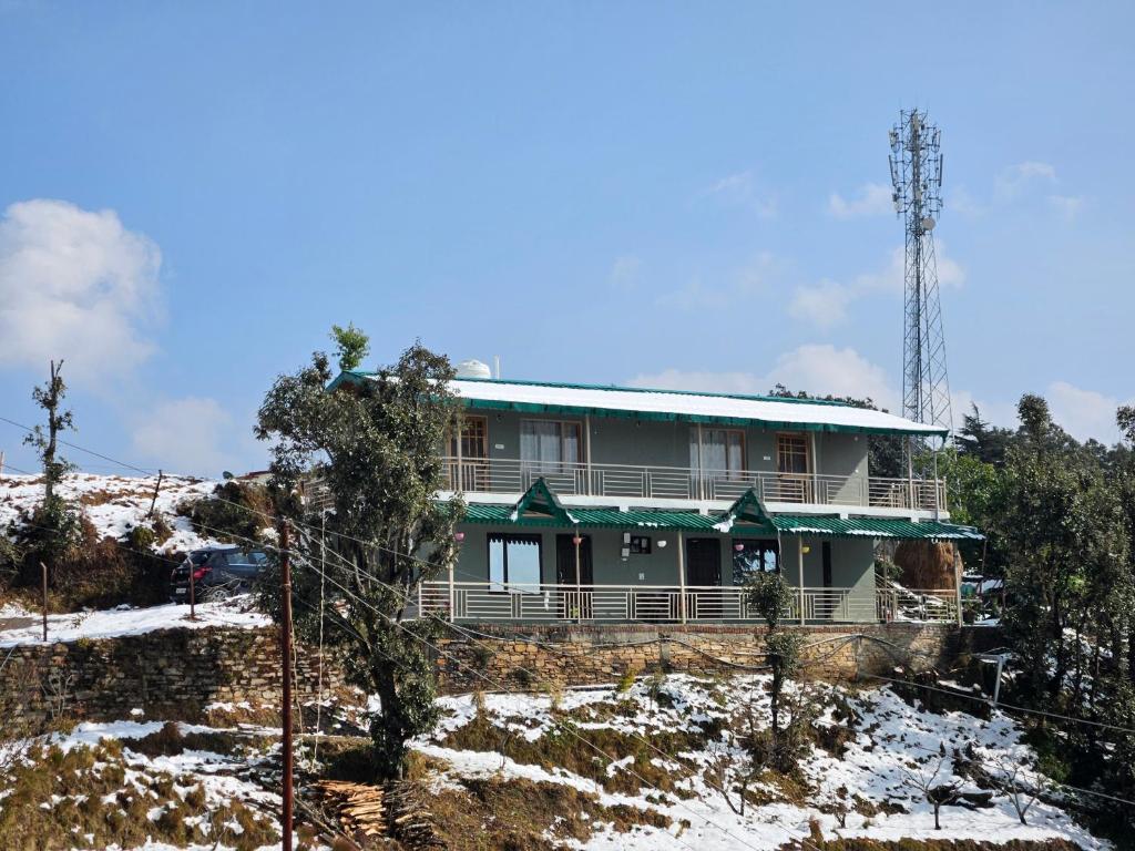 a house on a hill in the snow at The Northern Nook in Mukteshwar