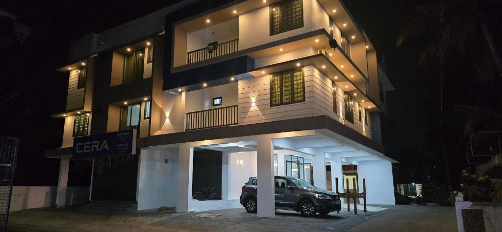 a car parked in front of a building at night at Philip's Signature Suites in Cochin
