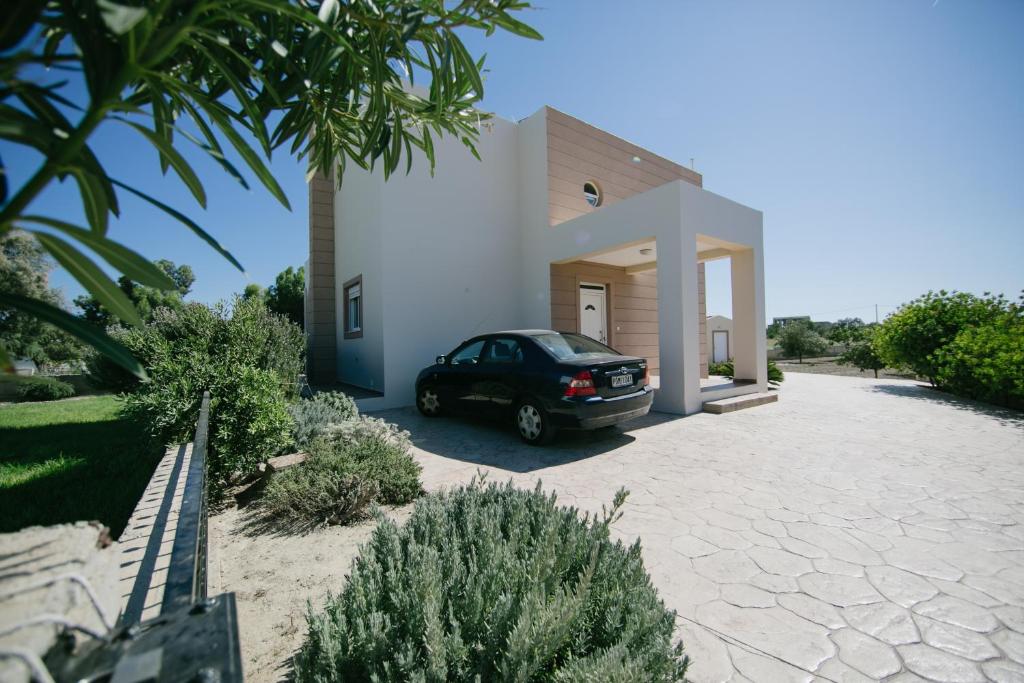 a car parked in front of a house at Evi's Sea View Villa in Gennadi